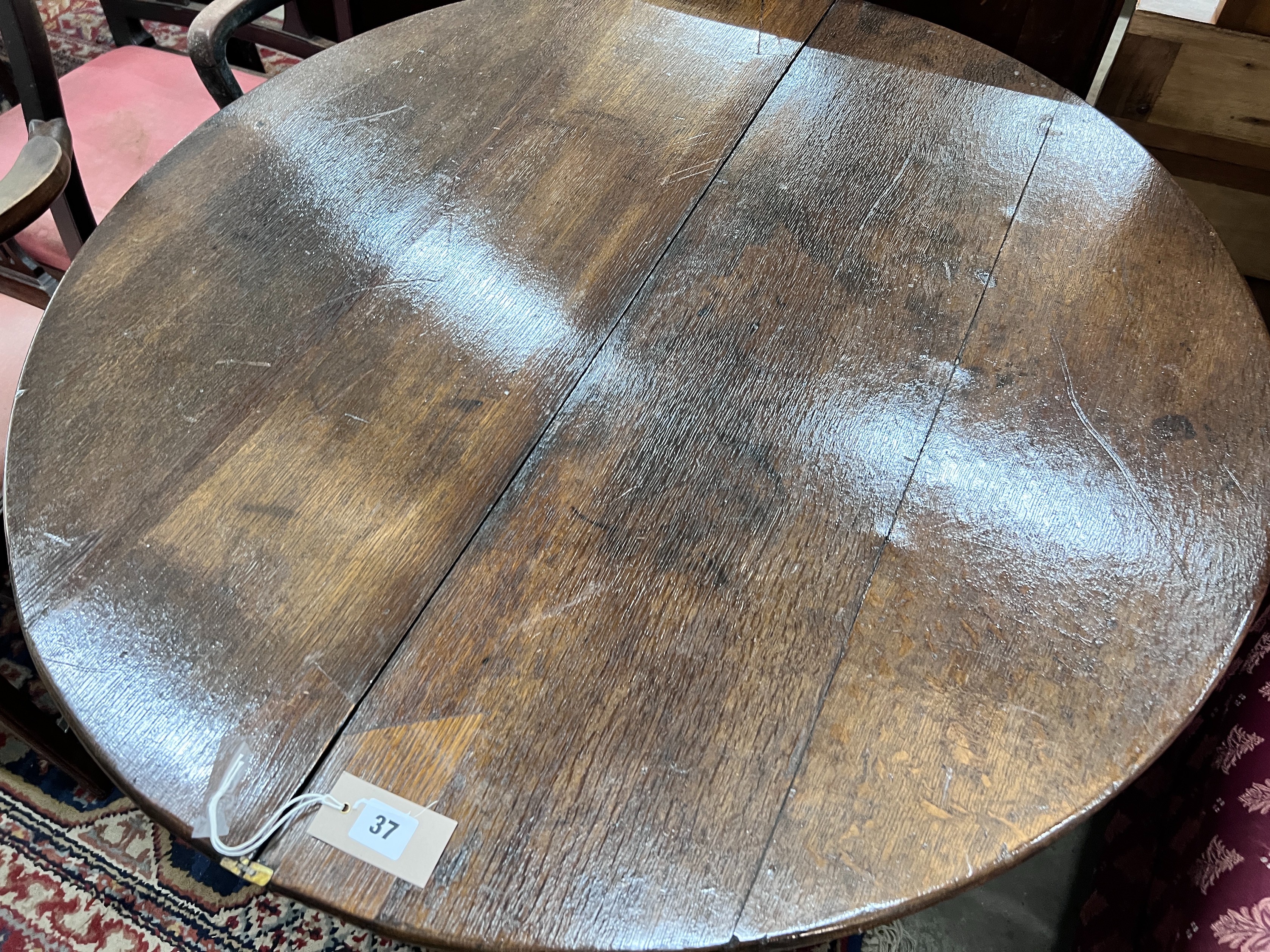 A late 17th century oak D shape folding tea table, diameter 94cm, height 70cm *Please note the sale commences at 9am.
